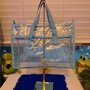 Brand new. Transparent, very thick and durable Tote with Blue Trim